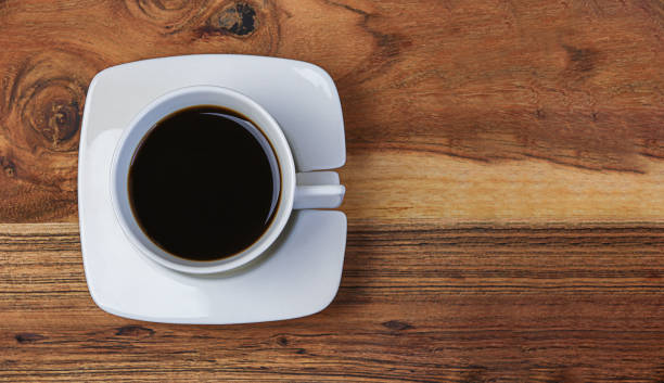 istock White cup of coffee on wooden background 1479699760