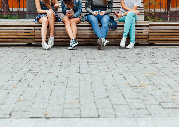 Teens hanging out on the bench