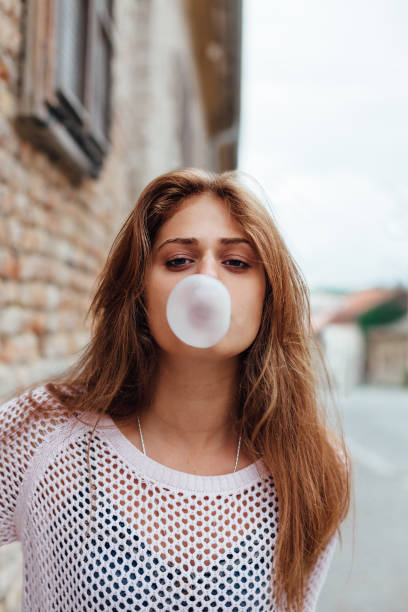 istock Adorable young woman making chewing gum 1479701486