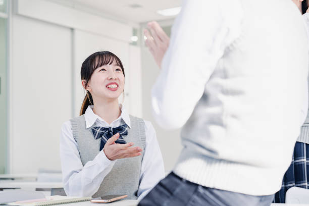 istock High school students chatting with classmates in the classroom 1479702428
