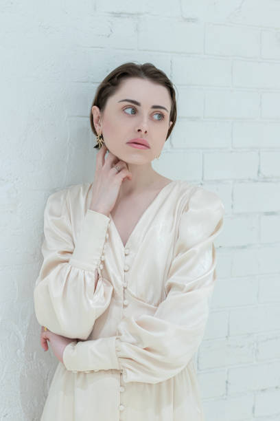 istock Young graceful woman closeup on the brick white wall 1479703135