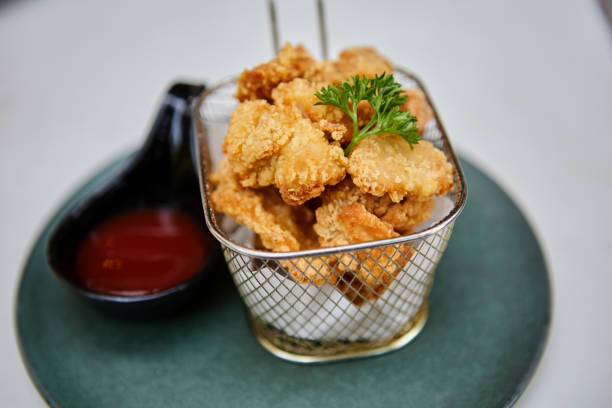 istock Crispy fried chicken in fryer basket with ketchup 1479703146