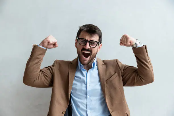 Photo of Young businessman office worker born leader successful in business and profession motivated for work and progress standing contentedly in office and smiling