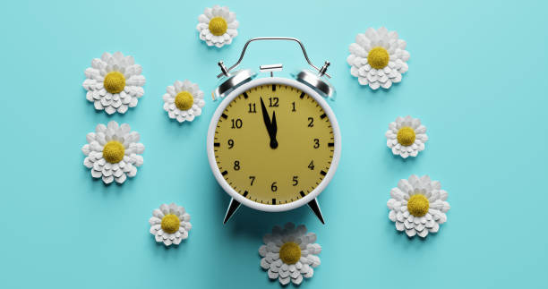 istock Alarm clock surrounded by flowers. Transitional change of summer time, daylight saving. 3d 1479706963