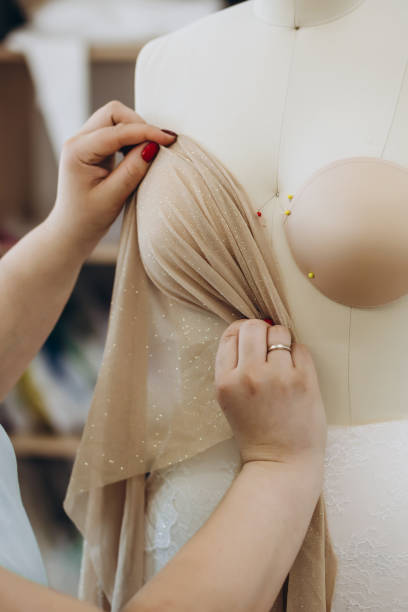 istock A creative designer is checking a fabric on the mannequin. 1479710414