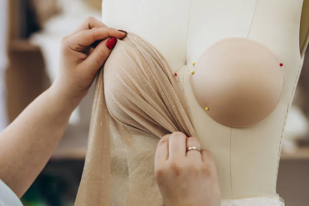 istock Woman at work is presenting her new fabric on a mannequin. 1479710426