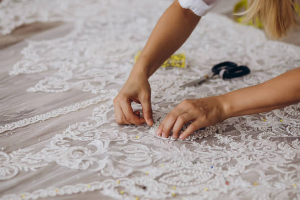 istock A blond dressmaker is creating a beautiful white ornament. 1479710430