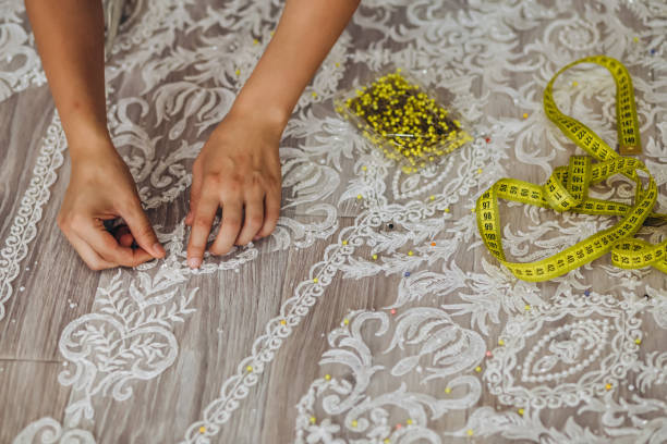 istock A crafter is sewing something on the wedding dress. 1479710474
