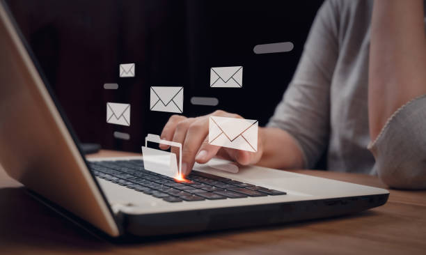 istock Email marketing, data center and internet advertising concept, inbox, online communication. Person reading e-mail on laptop computer, receive new message with electronic mail icons on virtual screen. 1479711291