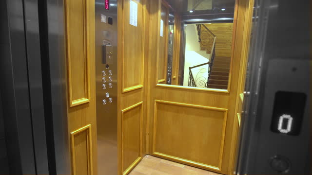 Door of empty elevator in luxury building open and close