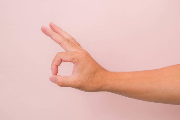 istock Male hand showing okay gesture isolated on pink background. 1479715880