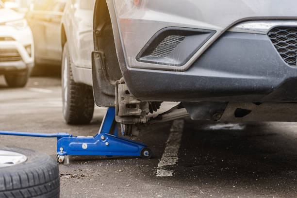 istock Car wheel replacement. Self-service tire fitting concept. Using a wheel wrench to twist the wheel nuts. 1479719072