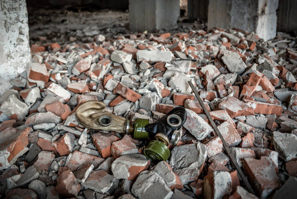 Two abandoned gas mask on the ruins. Broken bricks