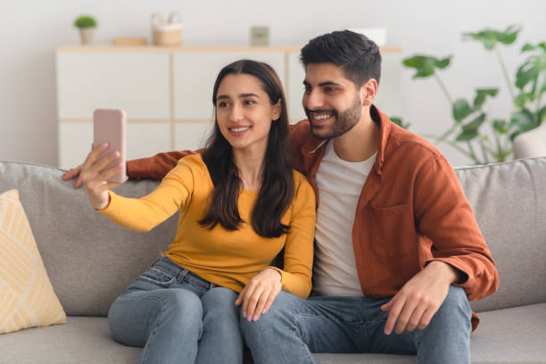 istock Happy Arabic Spouses Making Selfie Using Mobile Phone Indoor 1479721236