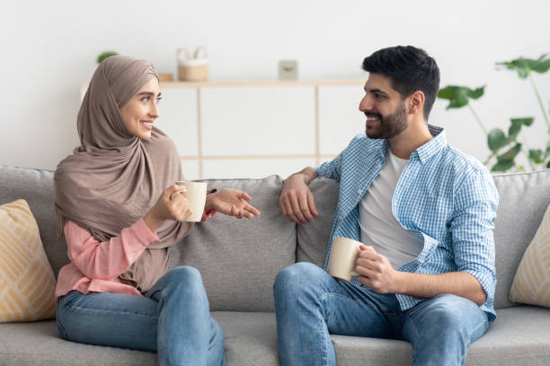istock Cheerful Middle Eastern Spouses Drinking Coffee And Talking At Home 1479721777
