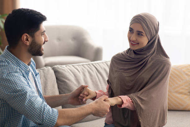 istock Islamic Spouses Holding Hands Smiling To Each Other At Home 1479721785