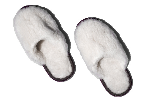 Handmade woolen slippers in isolation on white background. Soft comfortable shoes for home..