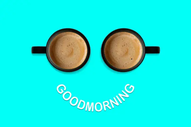 Smiling face made with two cups of coffee. Goodmorning concept.