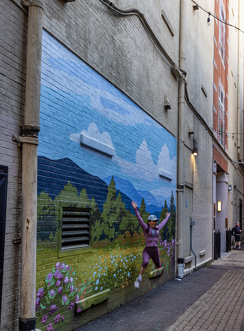 Knoxville, Tennessee, USA - March 25, 2023: Mural Alley where people take pictures of them and have pictures taken of a very popular place.