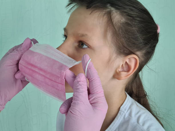 istock Doctor puts protective mask on child concept 1479729630