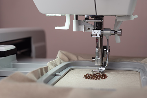 Embroidery and application with embroidery machine. Close-up and selective focus