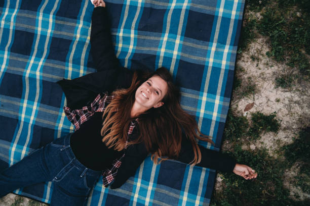 istock An happy woman is lying down on a blanket 1479735184