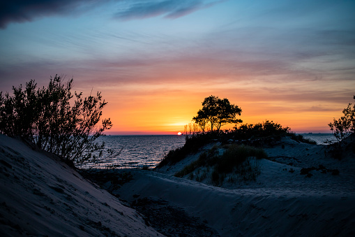 Sunset over sandy beach and dunes resort village on the Baltic Sea coast