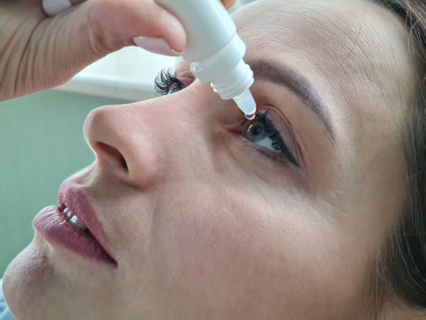 istock Woman face and dripping eye drops closeup 1479736323