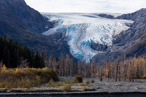 A stunning landscape displays a glacier atop a mountain peak, symbolizing the awe-inspiring power of nature.
