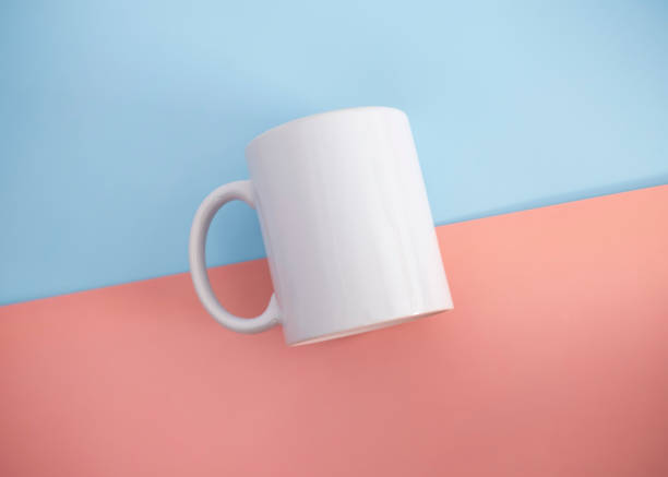istock White mug on a blue and pink background. Minimalism. 1479736500