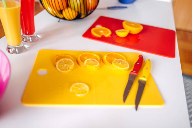 Woman making juice at home using orange and lemon fruit