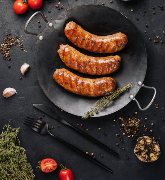 istock fried sausages on black pan from above 1479740518