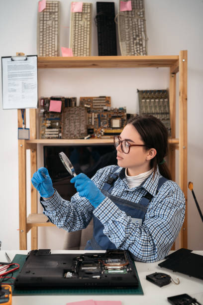 istock The technician holding a CPU of the laptop computer motherboard and looking through magnifying glass. computer, service, electronics, hardware, repairing, upgrade and technology. 1479744820