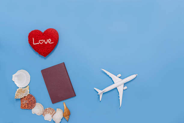 istock Holiday blue background with red heart shaped  ,seashells, passport. 1479746768