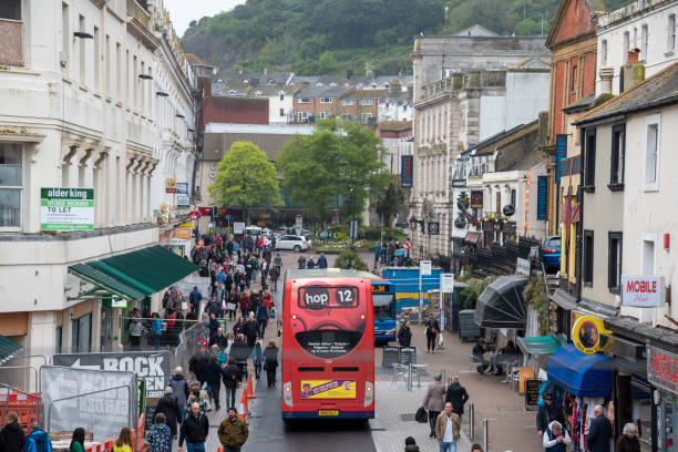 TORQUE,DEVON,ENGLAND-MAY 02,2015-Red bus in a fleet street in Torque, UK