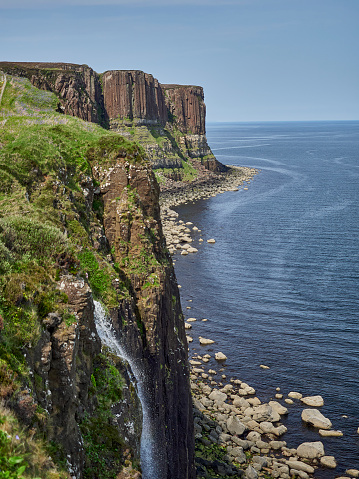iconic Kilt Rock and Mealt Falls along the coastline of the atlantic ocean on the Isle of Skye in Scotland, UK