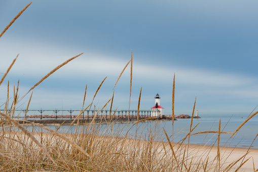 Michigan City Lighthouse and beach with storm clouds approaching.  Michigan city, Indiana, USA.