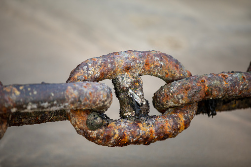 Rusting nautical chains in a harbour in Cornwall, UK.