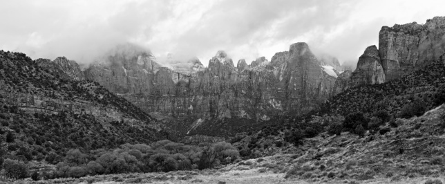 Black and white panorama view of the Towers of the Virgin in the morning clouds in Zion National Park, Utah.