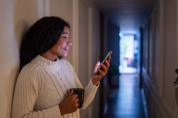 istock Young woman learning online from home with her cell phone 1479751010