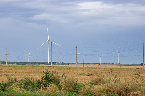 Windpower and agriculture. Wind turbines for electricity generation. Windmill renewable energy farm. Eco-energy of nature.