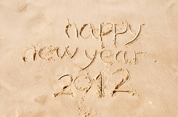 istock happy new year 2012 written in sand 147975454