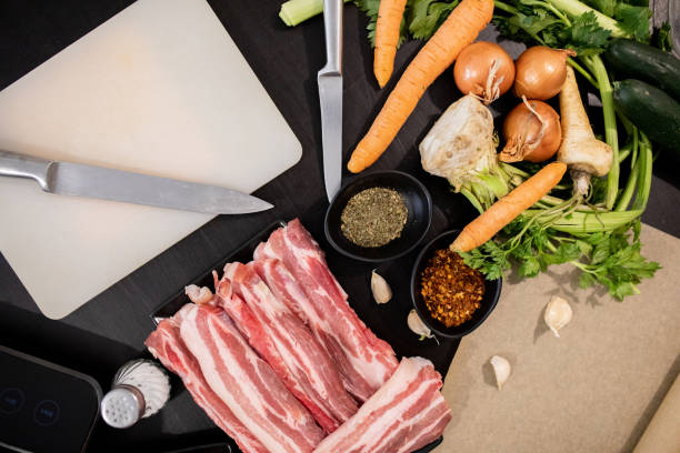 istock Pieces of raw pork and beef on a cutting board with vegetables 1479755199