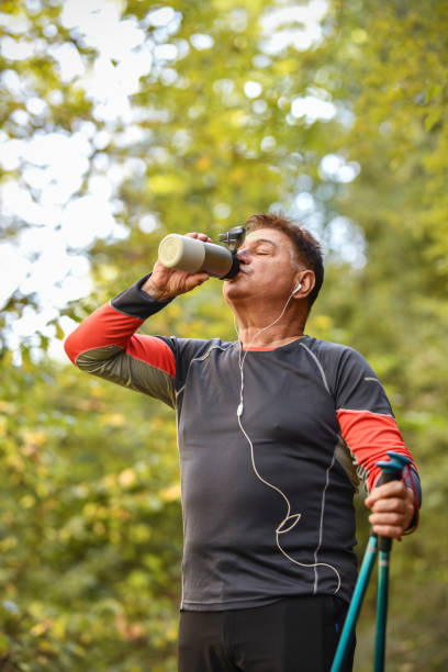 istock Fresh Drink For Senior Hiker Enjoying Forest Fun 1479760818