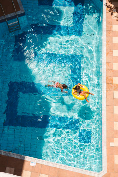 istock Children playing with inflatable ring in swimming pool 1479761187