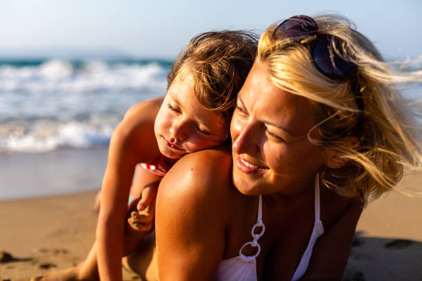 istock Mother cuddle with daughter on vacation 1479761805