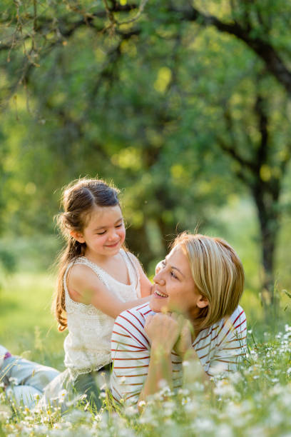 istock Mother and child having fun blowing dandelion seeds 1479761843