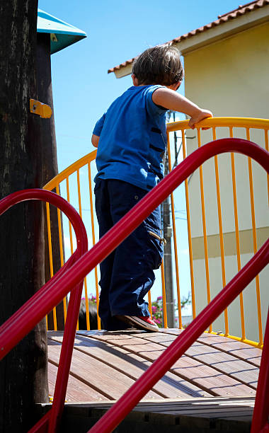 Boy playing in the playground. stock photo