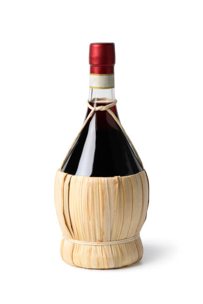 Traditional Italian bottle with Chianti wine close up on white background stock photo