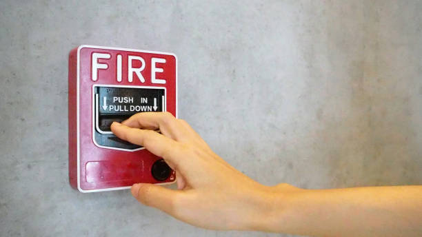 Fire alarm notifier or alert or bell warning equipment and hand use when on fire. Fire alarm notifier or alert or bell warning equipment and hand use when on fire. Notifier stock pictures, royalty-free photos & images